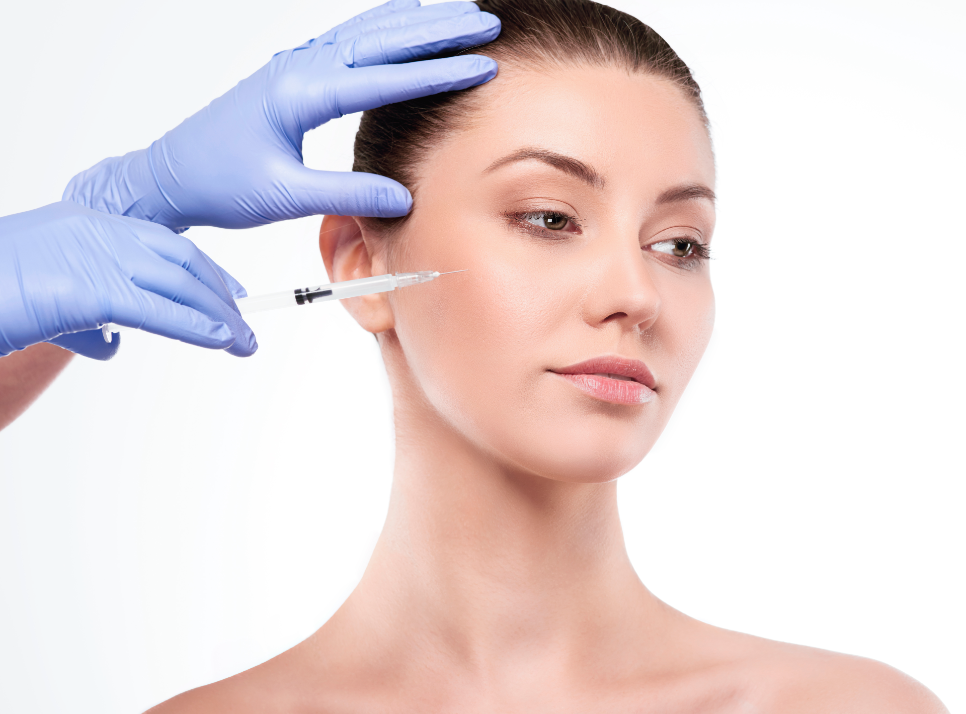 Clinician Wearing Blue Gloves Administers a Facial Injection to a Woman's Cheek with a Syringe Visible in Close-up